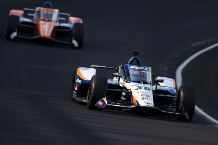 Japan's Takuma Sato races New Zealand's Scott Dixon on the way to victory in the 104th Indianapolis 500