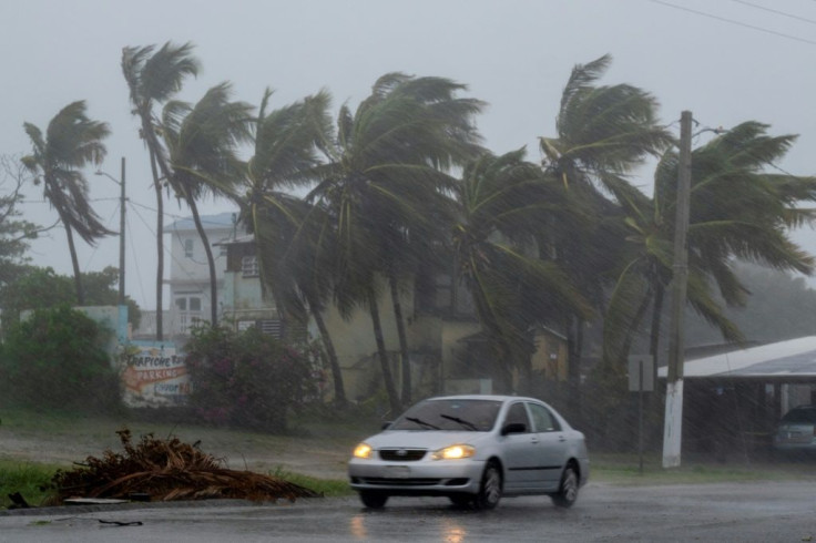 A car drives on a road as Tropical Storm Laura hits Guayama, Puerto Rico on August 22, 2020