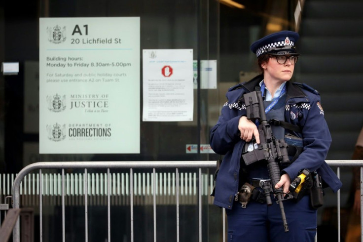 An armed police officer stands guard outside the Christchurch High Court