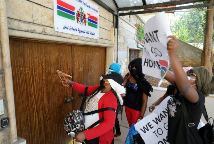 Protestors hammer the doors of The Gambia's consulate in Beirut demanding to be evacuated back to their country