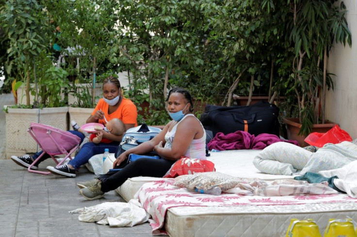 Kenyan women in Beirut camp outside their consulate asking to be repatriated home, some of the thousands of foreign workers wanting to leave  Lebanon