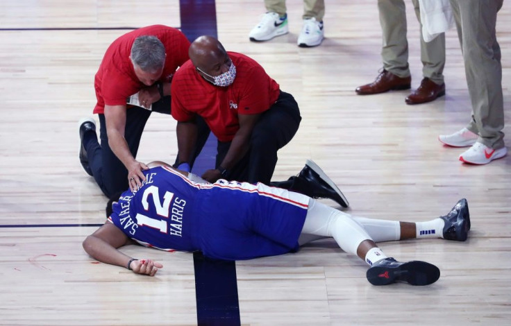 Coach Brett Brown and medical staff tend to Philadephia forward Tobias Harris after his hard fall in the 76ers NBA playoff loss to the Boston Celtics