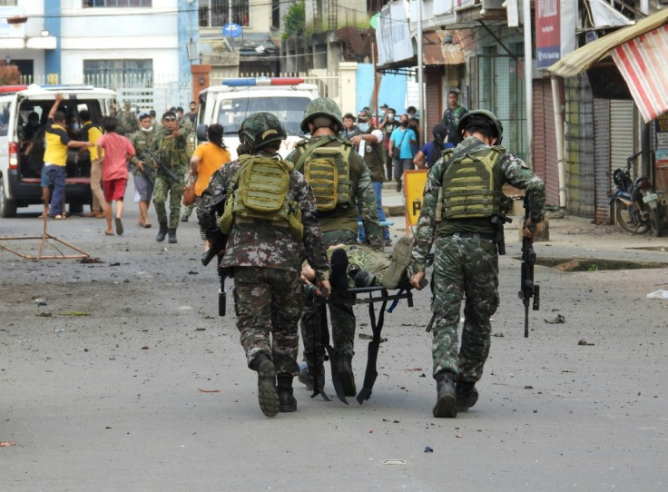 Soldiers stretcher away a colleague injured in a bomb blast in Jolo on Sulu island in the Philippines