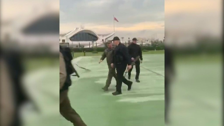 Grab taken from a video released by Belarus state agency "Belta" shows President Alexander Lukashenko holding an automatic rifle and wearing body armour in Minsk