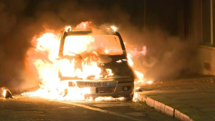 A car is set on fire and a shop near the Champs-Elysees is looted after the Champions League final as some Paris Saint-Germain fans are angered by their team's defeat in Lisbon.