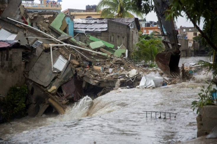 Houses collapsed after floodwaters ran through the streets of Santo Domingo as Tropical Storm Laura batters the region