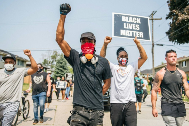 Demonstrators participate in a march on August 24, 2020 in Kenosha, Wisconsin over the shooting of Jacob Blake by police