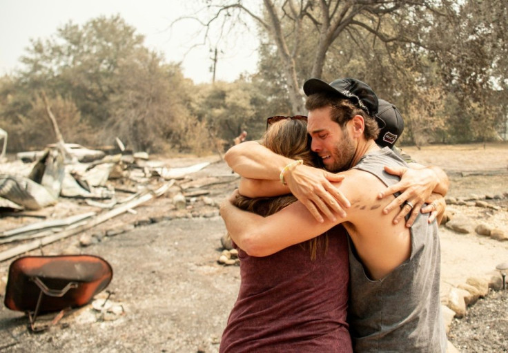 Resident Austin Giannuzzi cries while embracing family members at the burned remains of their home during the LNU Lightning Complex fire in Vacaville, California on August 23, 2020