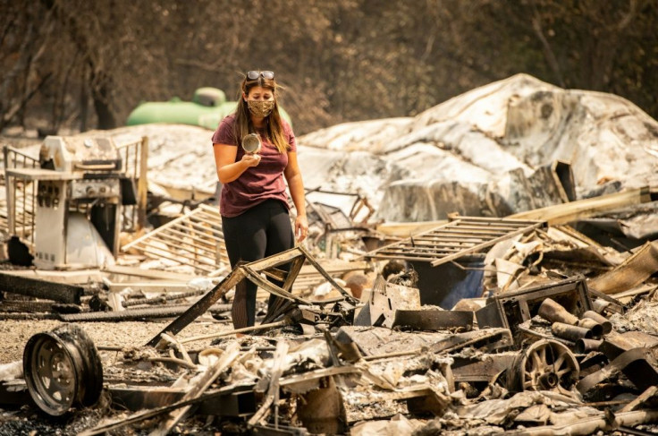 Resident Alyssa Medina reacts after finding an intact cup amidst the burned remains of her home during the LNU Lightning Complex fire in Vacaville, California on August 23, 2020