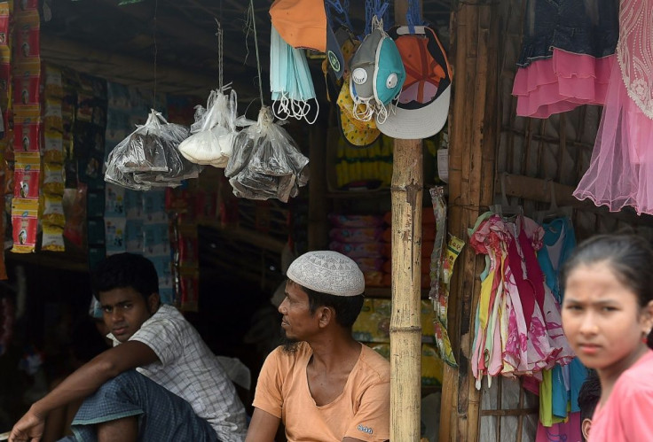 A Rohingya shopkeeper sells face masks as a preventative measure against COVID-19 in Kutupalong refugee camp, in Ukhia, Bangladesh