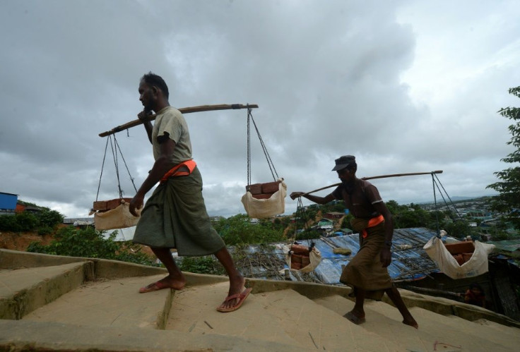 Rohingya men carry bricks for construction work in Jamtoli refugee camp, near Ukhia, Bangladesh
