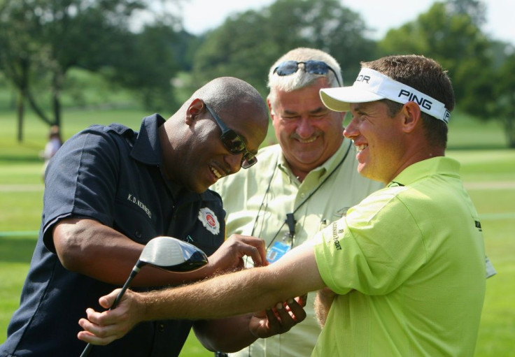 All in a day's work: Chief referee John Paramor (centre) watches Lee Westwood get treatment for a wasp sting at the 2008 WGC Invitational at Akron, Ohio