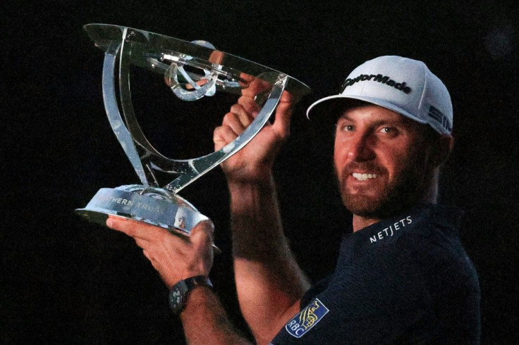 Dustin Johnson celebrates with the trophy after going 30-under par to win The Northern Trust at TPC Boston