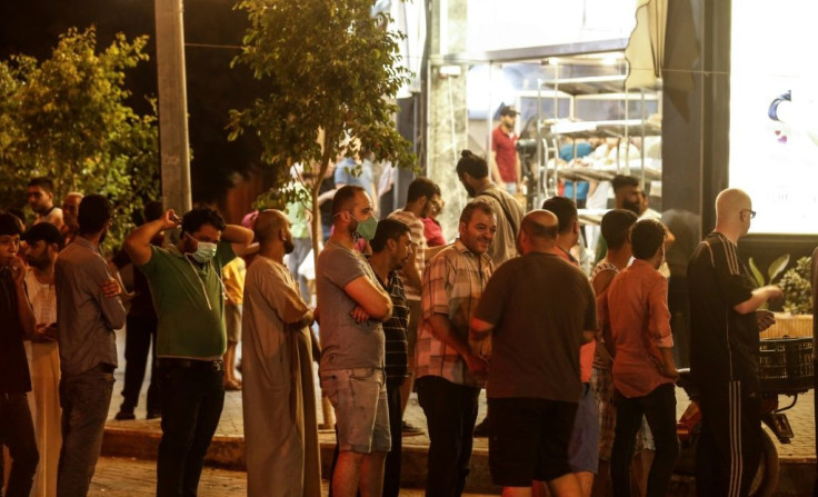 People queue at a bakery in Gaza City after new lockdowns were announced across the city due to cases of the novel coronavirus late on August 24, 2020