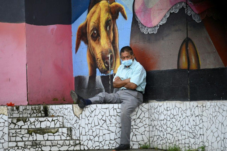 A man rests in a park after the government eased lockdown measures after five months of quarantine in San Salvador on August 24, 2020