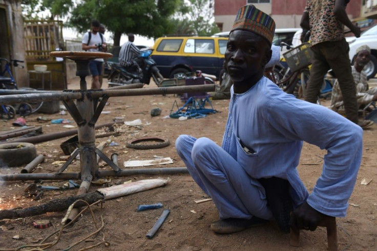 A polio victim arrives in his welding workshop in Kano, northern Nigeria