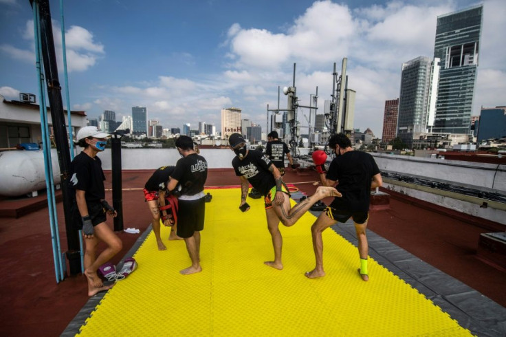 People take part in a Muay Thai martial art class on a roof in Mexico City, on August 15, 2020, as the country stuggles to get in shape amid the coronavirus pandemic