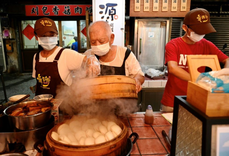 80-year-old Wu Huang-yi prepares his gua-bao -- flat steamed buns -- at the Huaxi Night Market in Taipei
