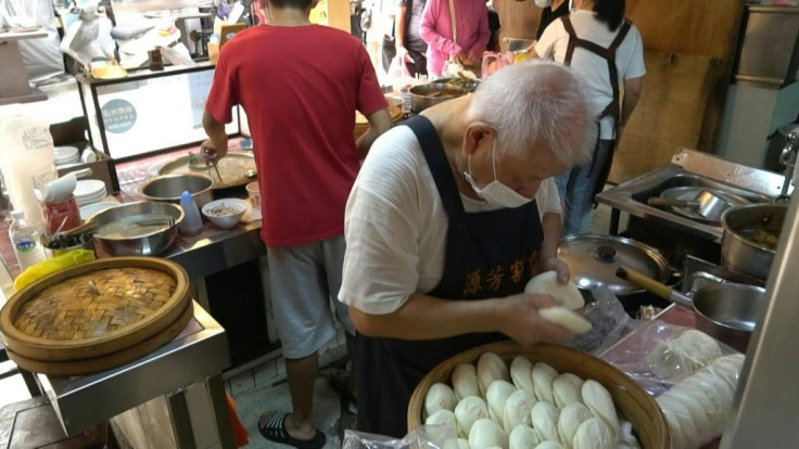 It is lunchtime at Taipei's Huaxi Night Market -- the capital's oldest -- and a queue has already formed outside Wu Huang-yi's stall, with diners eager to taste the pork belly whose aroma wafts from a steel pot bubbling in the cramped kitchen.