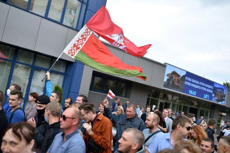 Belarusian car workers marched Wednesday in support of strikers detained by police