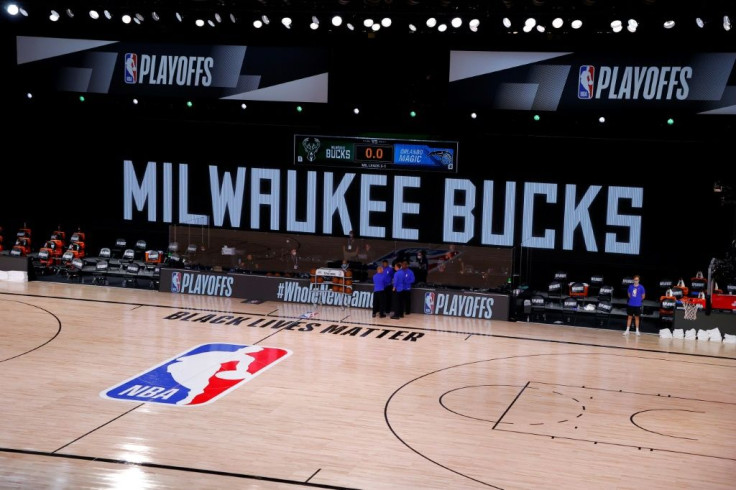 Referees huddled at the edge of an empty court Wednesday as the Milwaukee Bucks and Orlando Magic did not arrive for the scheduled start of their NBA playoff contest