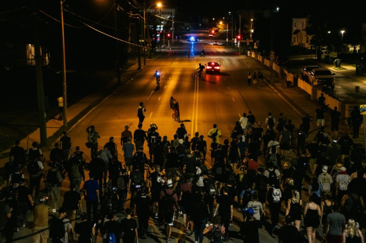 Demonstrators march in the streets of Kenosha, Wisconsin for a fourth night