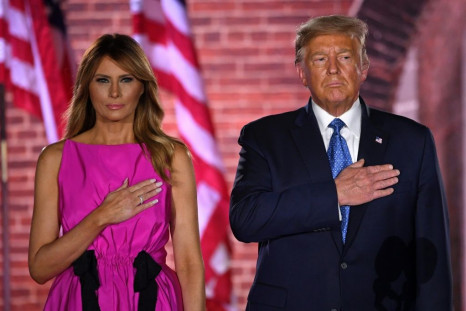 President Donald Trump and his wife, Melania, listen to the US national anthem during the third night of the Republican National Convention