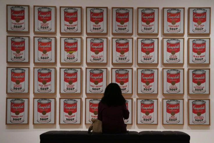 A woman looks at "Campbell's Soup Cans"  by Andy Warhol as the Museum of Modern Art (MoMA) reopens its doors to the public on August 27, 2020 in New York, after being closed since March 12, 2020 due to Covid-19