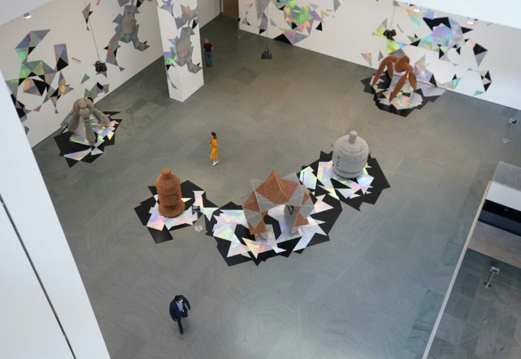 People walk around the atrium as the Museum of Modern Art (MoMA) reopen its doors to the public on August 27, 2020 in New York, after being shuttered since March 12, 2020 due to Covid-19