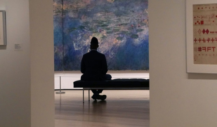 A man looks at Claude Monet's "Water Lilies" as the Museum of Modern Art (MoMA) reopen its doors to the public on August 27, 2020 in New York after being shuttered since March 12, 2020 due to Covid-19