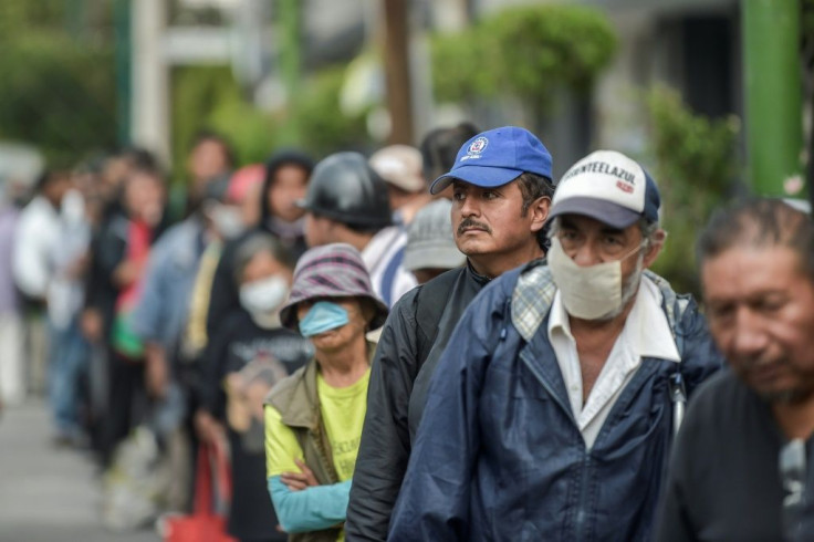 Homeless people queue to receive food in Mexico City, where poverty is on the rise due to the coronavirus pandemic