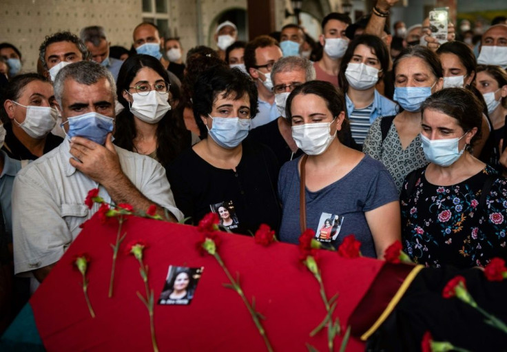Relatives and mourners gather around the coffin of Turkish lawyer Ebru Timtik during her funeral in the Gazi District of Istanbul on Friday