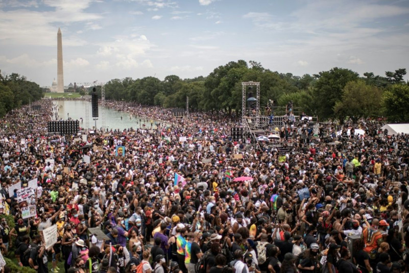 A large crowd protested against racism in Washington, DC on the same day as President Donald Trump's speech in New Hampshire