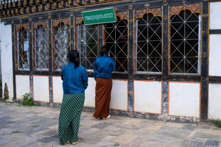 Women line up to buy cigarettes outside a store in Bhutan