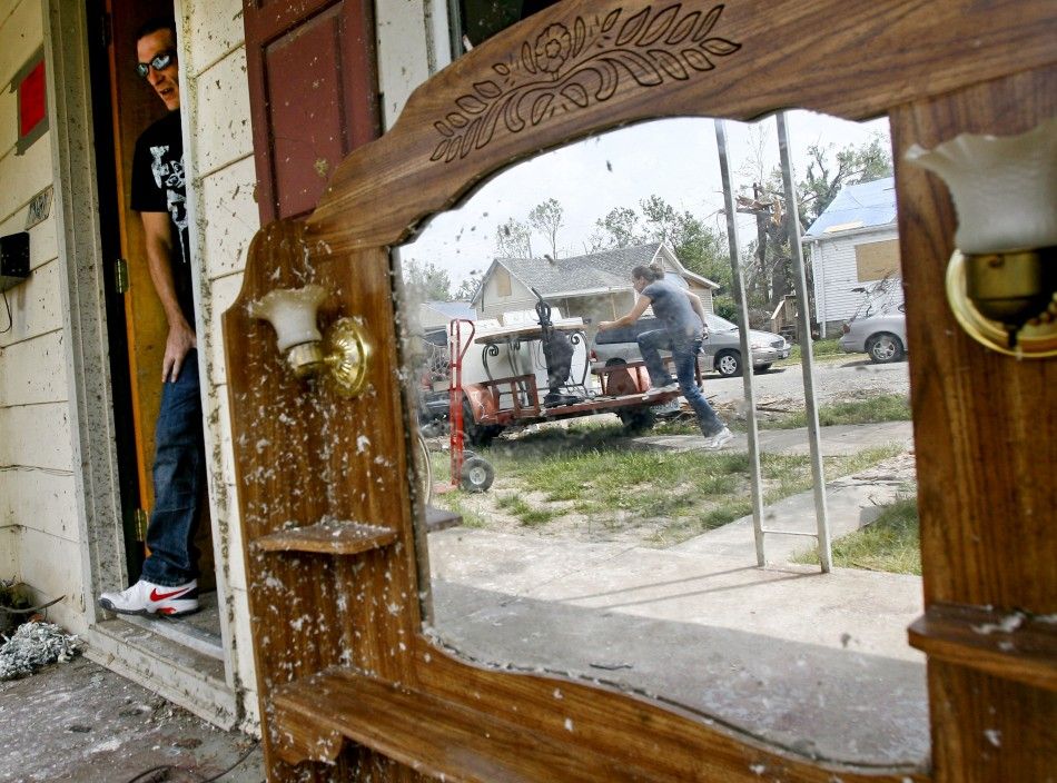 Brad Carter leaves his damaged house after the May 22 tornado in Joplin