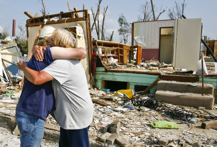 Michael Phillips and Kathi Gale embrace outside their home which was destroyed by the May 22 tornado in Joplin