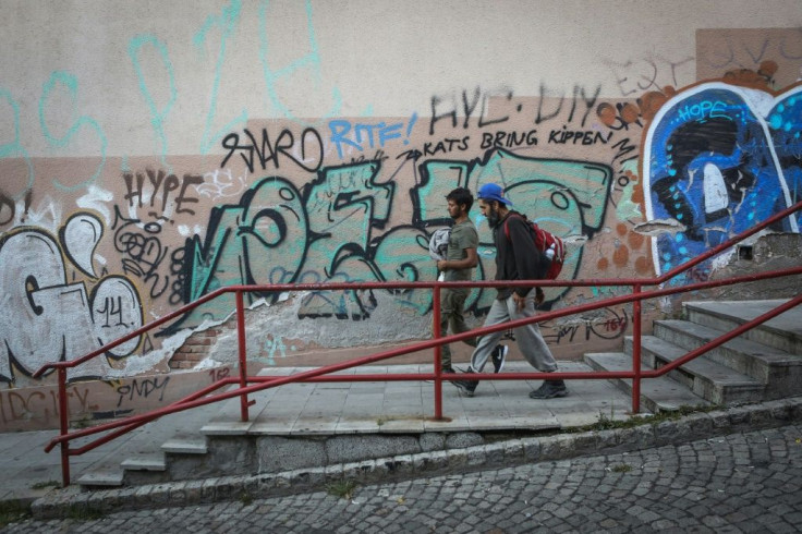 A group of migrants walk in downtown Belgrade