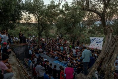 Migrants pray during Muharram celebrations at the refugee camp of Moria