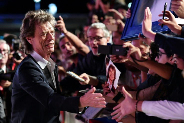 Mick Jagger signing autographs in 2019 but the fans will be kept clear of the red carpet this year