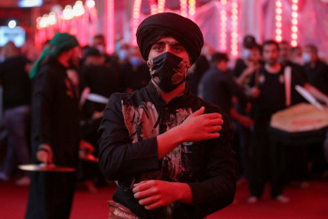 A Shiite Muslim worshipper commemorates the martyrdom of the Prophet Mohammad's grandson Imam Hussein at his shrine in the Iraqi city of Karbala