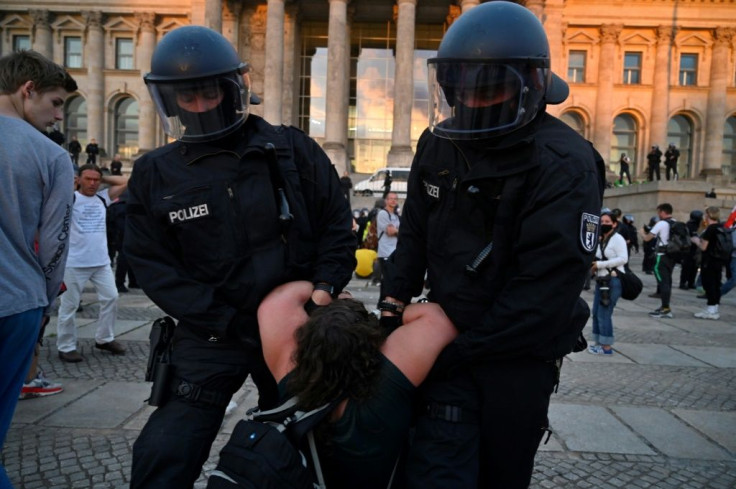 Several hundred protesters broke through barriers and a police cordon to climb the steps leading to the entrance to the Reichstag