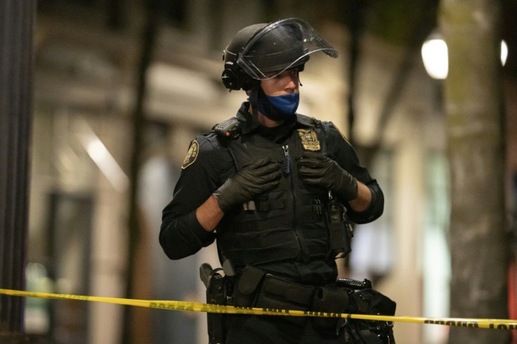 A Portland police officer guards the scene of a fatal shooting near a pro-Trump rally on August 29, 2020 in Portland, Oregon