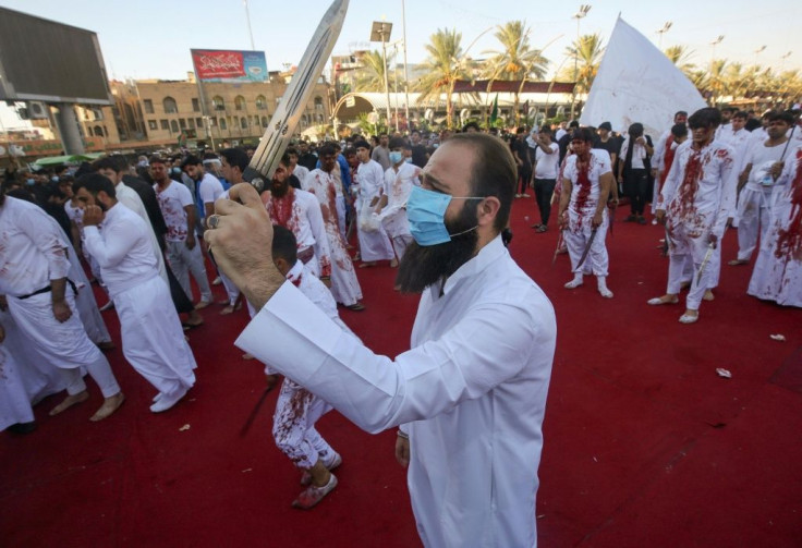 Iraqi Shiite Muslim men take blades to their heads streaming blood to signify grief, to commemorate Ashura, amid the COVID-19 pandemic, in the holy city of Karbala