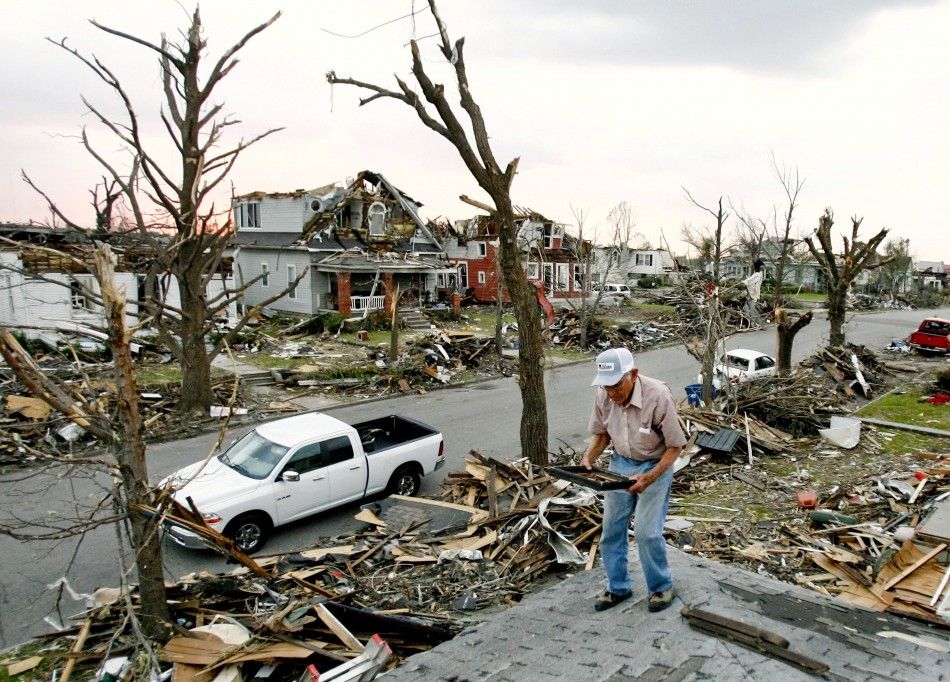 Hugh Hills salvages items from the upper level of his house which was destroyed in the May 22 tornado in Joplin