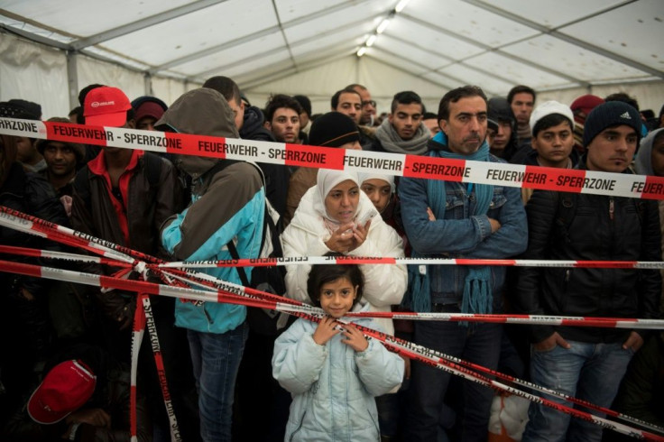 Migrants queue at an asylum centre in Berlin in October 2015, among a million who will flood into Europe during its worst migrant crisis since WWII