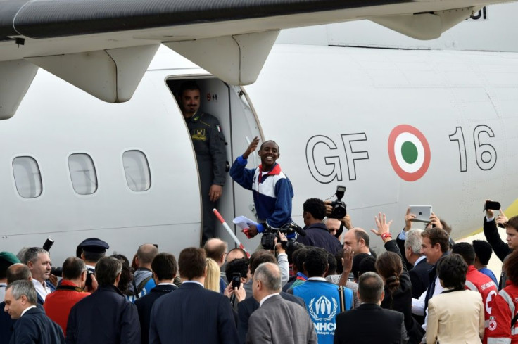 An Eritrean asylum seeker boards a plane for Sweden under a new European relocation programme on October 9, 2015 at Rome Ciampino airport