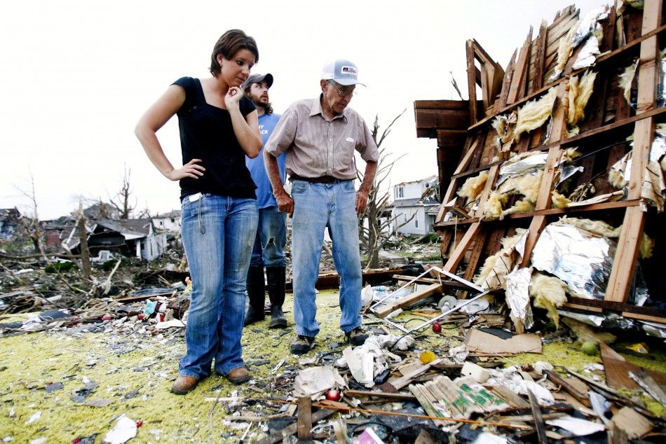 Jamie Haun, William Haun and Hugh Hills survey Hill039s house which was destroyed in the May 22 tornado in Joplin