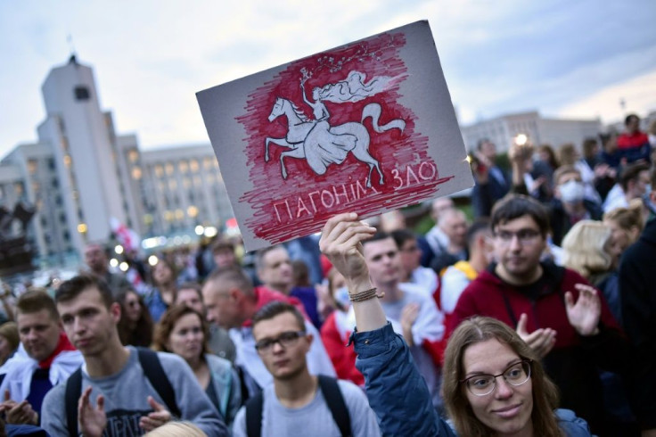 A placard urgers regime opponents to "drive away evil" at an August 25 rally -- but analysts have warned ongoing unrest could hit the economy hard