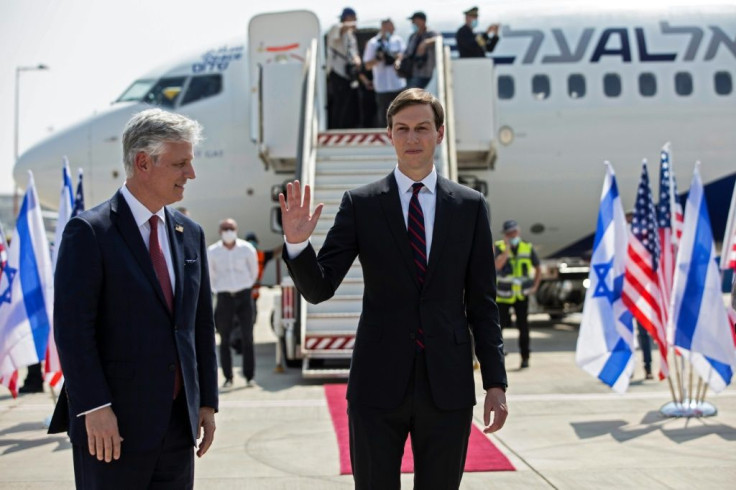 US Presidential Adviser Jared Kushner (R) waves as he stands next to US National Security Adviser Robert O'Brien ahead of boarding the El Al flight