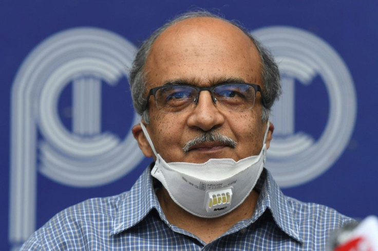 Prashant Bhushan smiles during a press conference in New Delhi after being fined a token one rupee (one US cent) for contempt of court